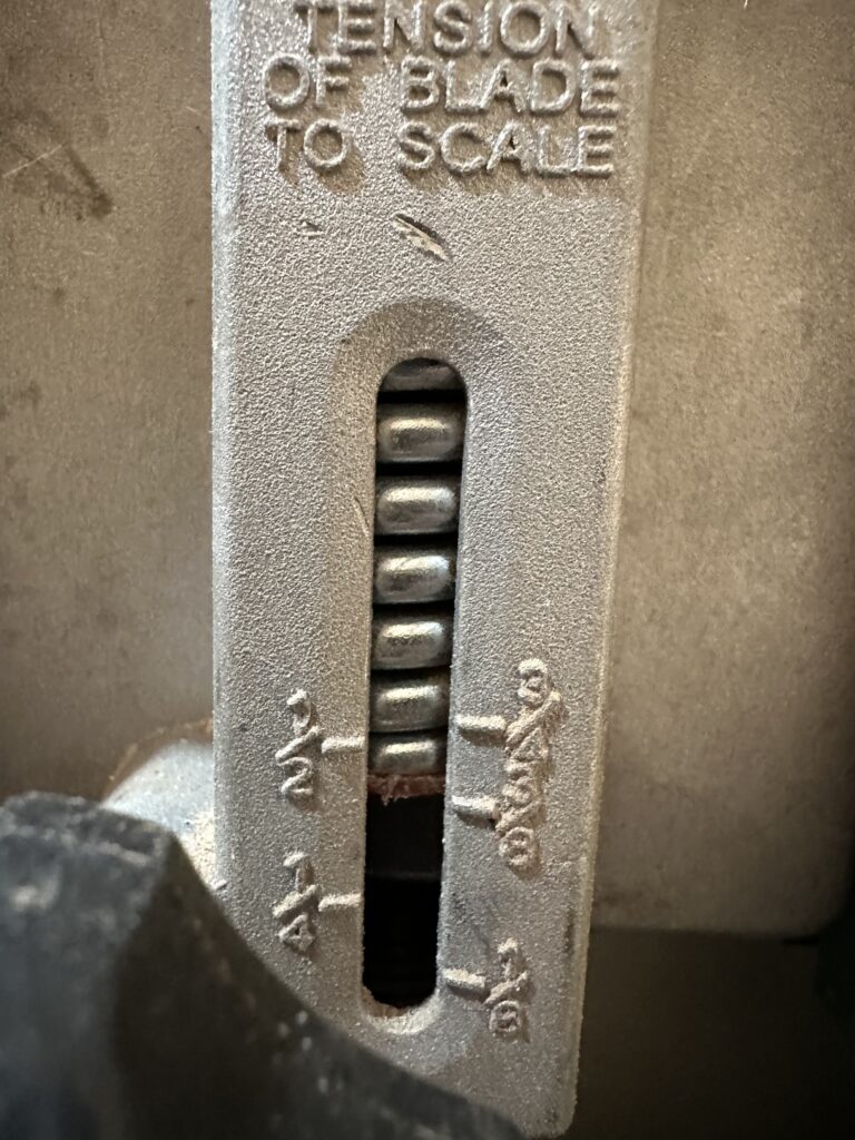 Tension gauge on the back of the bandsaw